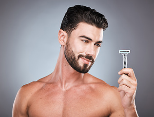 Image showing Face, shaving product and man with razor in studio isolated on a gray background. Epilation, haircare and thinking male model with facial tool to shave for wellness, health hygiene and hair removal.