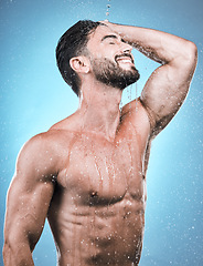 Image showing Body, man and water for cleaning, morning routine and grooming against a blue studio background. Skincare, male and gentleman with cosmetics, wet and drops for hygiene, beauty or wellness on backdrop