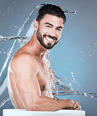 Image showing Water, splash and man in shower man, portrait for hygiene, .beauty and skincare isolated on blue background. Smile, face and cleaning body with muscle, sustainability and happy with natural cosmetics