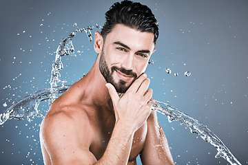 Image showing Water splash, beauty and shower with man in portrait for hygiene and skincare isolated on studio background. Hand, face and cleaning body with muscle, sustainable dermatology with natural cosmetics