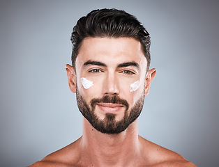 Image showing Skincare, cream and face portrait of man in studio isolated on a gray background for wellness. Cosmetics, dermatology and young male model with lotion, creme or moisturizer product for facial health.