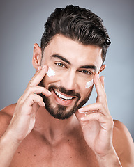 Image showing Skincare, happy and portrait of a man with face cream isolated on a grey studio background. Beauty, grooming and model with facial sunscreen for body dermatology, hygiene and protection on a backdrop