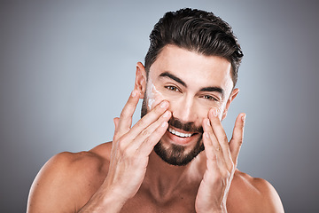 Image showing Face portrait, skincare and man with cream in studio isolated on a gray background for facial wellness. Cosmetics, dermatology or happy male model with lotion, creme or moisturizer product for health