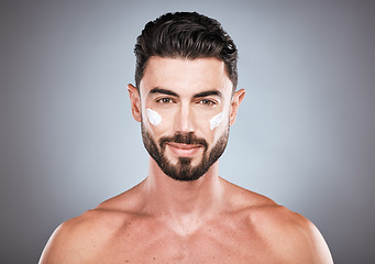 Image showing Face portrait, skincare cream and man in studio isolated on a gray background for wellness. Cosmetics, dermatology and young male model with lotion, creme or moisturizer product for facial health.