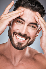 Image showing Face, skincare and man with cream in studio isolated on a gray background for facial wellness. Portrait, forehead cosmetics and happy male model apply lotion, healthy creme or moisturizer product.