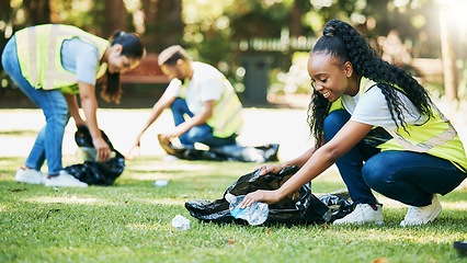 Image showing Volunteer people, cleaning park and community service for clean environment, recycling and pollution. Black woman happy to help group with plastic bottle and trash bag outdoor in green environment