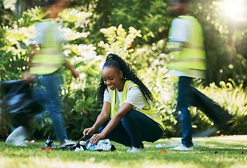 Image showing Black woman volunteer, cleaning park and community service for recycling and pollution. Black woman happy to help ngo group with plastic bottle, dirt and trash bag outdoor in green environment