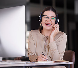 Image showing Call center, woman and writing notes for customer service, telemarketing sales and consulting at computer. Happy receptionist, communication and planning in notebook, solution and telecom management