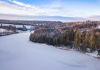 Image showing Aerial top down view of beautiful winter forest treetops.