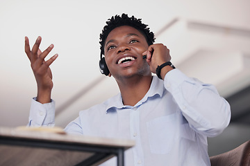 Image showing Call center, black man and communication in low angle for customer service, telemarketing and office consultant. Sales agent talking on headset for tech support, questions and telecom lead generation