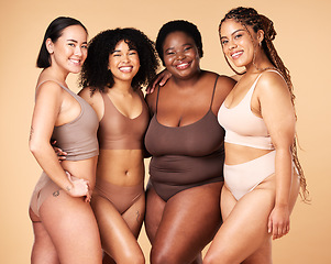 Image showing Body, diversity and portrait of different women group hug for inclusion, beauty and skincare. Aesthetic model people or friends on beige background with glow, underwear and motivation for self love