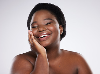 Image showing Black woman, hand and smile for skincare beauty, cosmetics or makeup against gray studio background. Portrait of happy natural plus size African American female smiling for self love, care or facial