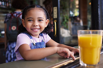 Image showing Happy, smile and portrait of a child at a restaurant for food, breakfast and juice. Playful, happiness and girl sitting in a cafe, coffee shop or store for lunch, dinner or meal with a drink