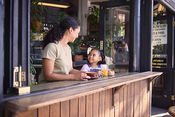 Image showing Coffee shop, black family and children with a mother and daughter enjoying a beverage in a cafe together. Juice, caffeine and kids with a woman and happy female child bonding in a restaurant