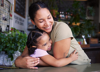 Image showing Cafe, mother and kid hug in restaurant for love, care and quality time together. Happy parent hugging girl child in coffee shop at table for happiness, smile and embrace for bonding, relaxing and fun