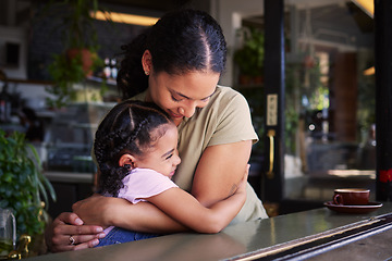 Image showing Cafe, mom and child hug in restaurant for love, care and quality time together. Happy mother hugging girl kids in coffee shop at table for happiness, smile and embrace for bonding, relaxing and fun