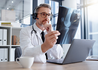 Image showing Doctor, x ray and man with headset and laptop in hospital for healthcare or online consultation. Thinking, radiology telehealth and mature medical physician looking at mammogram picture or bone xray.