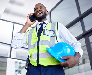 Image showing Black man, construction worker or phone call in building planning, networking or industrial property design in low angle. Smile, happy or engineering architect with mobile technology, helmet or ideas