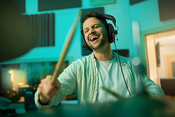 Image showing Musician, headphones and man drummer playing in a recording studio for production of a song. Musical artist, drums and male with a passion for music with a percussion instrument for entertainment.