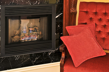 Image showing Fireplace and red chair
