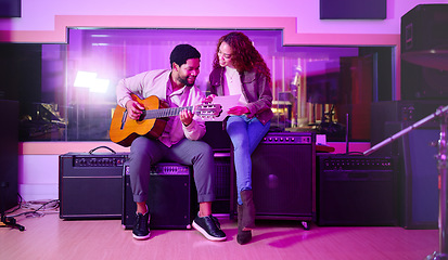 Image showing Black man, woman and songwriting with guitar, studio and night with paper for creative lyrics, notes and ideas. Music team, writing and singing together for professional production with teamwork