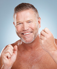 Image showing Dental, floss and face portrait of man in studio isolated on a gray background for health. Oral hygiene, wellness or happy senior male model with thread or string for flossing, cleaning or teeth care