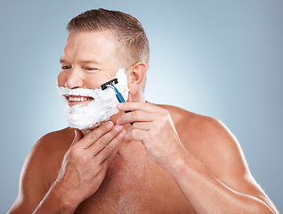 Image showing Face, razor and man with shaving cream in studio isolated on a gray background for hair removal. Thinking, skincare and happy senior male model with foam to shave for aesthetics, health or wellness.