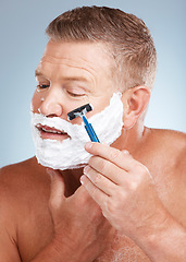 Image showing Face, shaving cream and man with razor in studio isolated on a gray background for hair removal. Cleaning, skincare and senior male model with facial foam to shave for aesthetics, health or wellness.