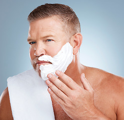 Image showing Shaving cream, product and old man in studio for skincare, grooming and beauty on grey background. Face, foam and hair removal for mature model relax with luxury, beard and treatment while isolated