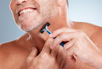 Image showing Epilation, razor and man shaving his face in a studio for a facial, skincare and hygiene routine. Health, wellness and mature male doing face hair removal treatment with a shaver by gray background.