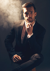 Image showing Portrait, smoke and man in suit, fashion and stylish guy against dark studio background. Face, male leader and gentleman with confidence, manager and leader for business, elegant outfit and executive