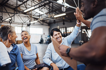 Image showing High five, group or team of fitness senior women at the gym after exercise, workout or training with personal trainer. Elderly, old and people happy, smile and excited for teamwork and motivation