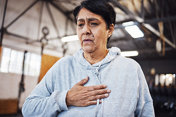 Image showing Senior woman with chest pain or injury in the gym after a intense workout or training. Healthcare, sick and elderly lady in retirement with asthma or breathing problem during exercise in sport center