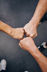 Image showing Hands, motivation and collaboration with people in the gym from above for health, fitness or solidarity. Teamwork, training and partnership with an athelte group doing a fist bump together for unity