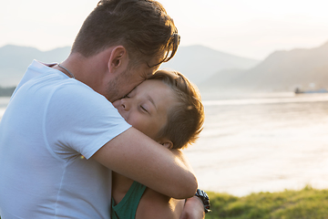 Image showing Father and his son playing and hugging outdoors