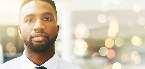 Image showing Portrait, mindset or mockup and a business black man posing with flare or overlay in the office for work. Face, vision and serious with a male employee posing on a lensflare background while working