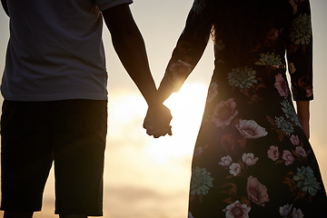 Image showing Trust, love and couple holding hands in support of marriage, commitment and unity on sunset. Man, woman and people in solidarity of respect, empathy and care for hope in silhouette on Valentines Day