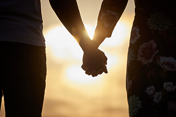 Image showing Holding hands, love and trust by couple in support of marriage, commitment or unity at sunset. Man, woman and silhouette in solidarity of respect, empathy and care while united on Valentines Day