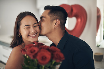 Image showing Love, rose and valentines day with a couple kissing in their home, in celebration of romance. Dating, flower boquet or surprise with a man and woman in a house to kiss while bonding in intimacy