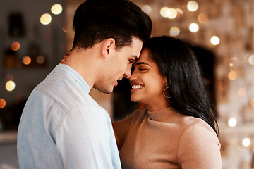 Image showing Love, romance and couple hugging while on a date for valentines day or anniversary celebration. Happy, intimate and young interracial man and woman embracing while at romantic evening dinner together