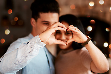 Image showing Love, heart and couple in restaurant, happiness and bonding on Valentines day, affection and loving together. Romance, hand sign and man with woman, romantic and celebration for relationship and date