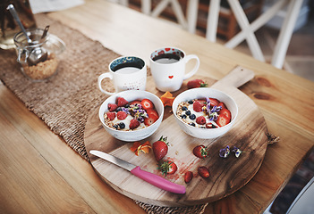 Image showing Breakfast, muesli cereal and diet above on table of fruit, wheat or oats and organic food for wellness or at home. Bowls in brunch prepared with cup of coffee for dieting plan, nutrition or fibre