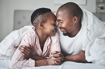 Image showing Love, relax and black couple lying in bed in a hotel for valentines day, anniversary or romance. Intimacy, happy and young African man and woman relaxing in bedroom while on romantic vacation or trip