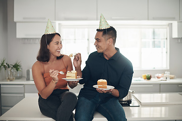 Image showing Birthday cake, celebration and couple in a kitchen, happy and relax while bonding in their home, smile and laugh. Party, people and man with woman on counter for eating, fun and celebrating in Japan