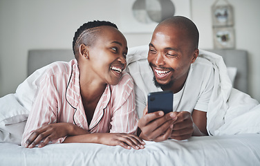 Image showing Phone, social media and morning with a black couple in the bedroom together to relax on a bed in their home. Mobile, meme or contact with a man and woman browsing the internet, relaxing or bonding