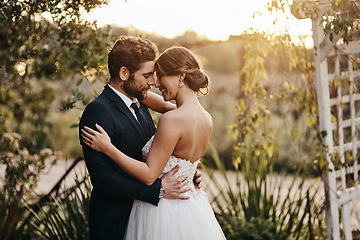 Image showing Wedding, love and couple in garden for marriage, ceremony celebration and commitment. Save the date, trust and bride and groom hug, embrace and happy to celebrate romance, smile and loving in park