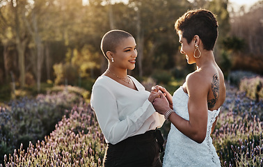 Image showing Woman, lesbian couple and holding hands in marriage for wedding with smile for LGBT relationship in nature. Happy gay married women touching hand and smiling for romance, vow or loyalty outside