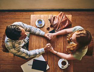 Image showing Top view, couple and holding hands in cafe, celebration and relax together, Valentines day and romance. Romantic, man and woman with love, coffee shop and talking for relationship, loving and bonding