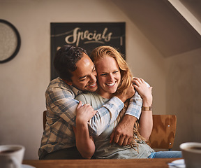 Image showing Happy couple, hug and smile in date at cafe for romance, embrace or relationship happiness indoors. Young man hugging woman and smiling for fun love or dining spending bonding time at restaurant