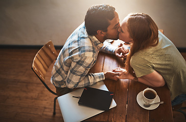 Image showing Cafe, kiss and couple on a coffee shop date together holding hands with love and care. Morning, restaurant above and happy young people with tea dating with happiness at a table with a hot drink